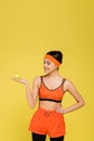 sportive woman with ripe apple standing