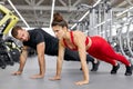 Sportive young couple doing push ups together Royalty Free Stock Photo