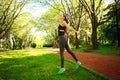Sportive young fitness woman jumping in summer park Royalty Free Stock Photo