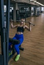 Sportive young woman is engaged in the gym. Upper block thrust. Healthy lifestyle