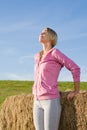 Sportive young woman relax by bales sunset Royalty Free Stock Photo