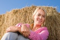 Sportive young woman relax by bales sunset Royalty Free Stock Photo