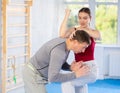 Young girl practicing self-defense techniques in pair with middle-aged man Royalty Free Stock Photo
