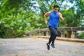 Sportman runner practicing sprinting run on road in park in morning