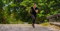 Sportman runner practicing sprinting run on road in park in morning