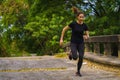 Sportman runner practicing sprinting run on road in park in morning