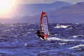 Sportman windsurfer on the lake surface. Royalty Free Stock Photo