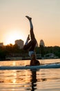 Girl training yoga in nature during sunset Royalty Free Stock Photo