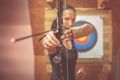 Young beautiful woman in sports competitions, archery, aiming at the target Royalty Free Stock Photo