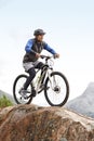 Sports, athlete and a man on a bike on the mountain for cycling, training and travel in nature. Idea, health and a male