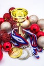 Sports awards and new year`s toys, medals and cups, red Christmas balls, winter competitions, new year`s holidays