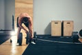 Man prepare to do exercises with barbell in a gym, keep barbell plate in hands Royalty Free Stock Photo