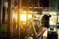 Sports background. Muscular fit woman exercising in fitness gym. on a cable machine simulator.