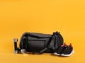 Sports bag and gym equipment on yellow background Royalty Free Stock Photo