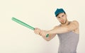 Sports and baseball training concept. Guy in grey tank top holds bright green bat. Royalty Free Stock Photo