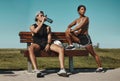 Sports, bench and fitness people with water bottle in a park for outdoor training, workout or wellness with blue sky