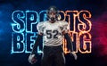 Sports betting on american football. Sportsman with ball in helmet on stadium in action. Bets in the mobile application. Royalty Free Stock Photo