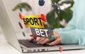 Sports betting concept on laptop computer screen on wooden table. Hands typing on a keyboard. All screen content is Royalty Free Stock Photo