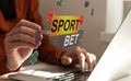 Sports betting concept on laptop computer screen on wooden table. Hands typing on a keyboard. All screen content is Royalty Free Stock Photo