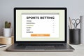 Sports betting concept on laptop screen on modern desk