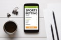 Sports betting concept on smart phone screen with office objects