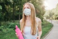 Sports blonde girl in a white medical mask jogging in the park healthy lifestyle during quarantine covid-19