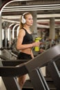 Sports blonde women on running track. female athlete on treadmill