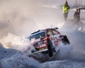 Sports car crashes into a snowdrift, kicking up a cloud of snow during the winter rally in Umea.