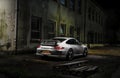 Sports car in front of an old factory night