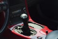 Sports car gear shift on a red console