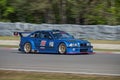 Blue fast car BMW 3 drives along a racing circuit. Royalty Free Stock Photo