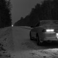 Sports car at night on a winter icy road in the absence of traffic