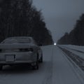 Sports car at night on a winter icy road in the absence of traffic