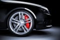 Sports car wheel with red brakes in studio lighting Royalty Free Stock Photo