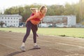 Sports cheerful family, healthy lifestyle, spring portrait of mother and little daughter having fun and running at the stadium Royalty Free Stock Photo