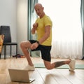 Sports coach doing squatting at home online