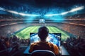 A sports columnist looks at the display during a football match Royalty Free Stock Photo