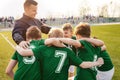 Sports Competition for Children. Boys Sports Team Huddle. Coach and Young Football Players Huddling Royalty Free Stock Photo