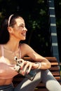 Sports confident girl resting after workout outdoor and drinks water from a bottle, leads a healthy lifestyle. Royalty Free Stock Photo