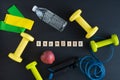 Sports equipment on black background for exercising at home. Word EXERCISE. Copy space Royalty Free Stock Photo