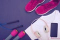 Sports equipment - clothes, sneakers, dumbbells jump rope and mobile phone with headphones Royalty Free Stock Photo