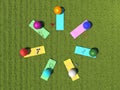 Sports equipment on the green meadow. Yoga mats and fitness balls lie in a circle on the grass in a top view. Group fitness or