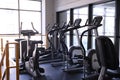 Sports equipment in the gym. Stylish bright sports space. Expanders and simulators with heavy dumbbells.