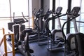 Sports equipment in the gym. Stylish bright sports space. Expanders and simulators with heavy dumbbells.