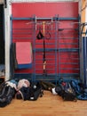 Sports equipment and gymnastics mats hang on the wall bars in the gym. Royalty Free Stock Photo