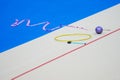 Sports equipment for rhythmic gymnastics lie on the edge of the carpet in the gym. Rhythmic gymnastics clubs, a ball, a hoop Royalty Free Stock Photo