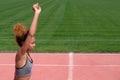 Sports exercises and stretching or preparing a runner to start at the stadium. A young beautiful African-American girl in a gray T Royalty Free Stock Photo