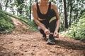 Sports female tying shoelaces on sneakers before jogging outdoor Royalty Free Stock Photo