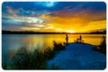 Sports Fishermen at Sunset early fall with beautiful water reflections and skyline over Ed Zorinsky lake Omaha Nebraska Royalty Free Stock Photo