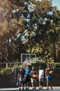 Sports, friends and basketball training at basketball court with group of men walking, talking and bonding before a